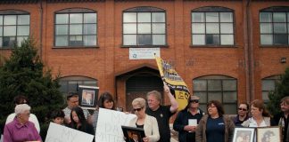 A scene from the 2019 documentary "Town of Widows" by Natasha Luckhardt and Rob Viscardis, which documents the fight for justice by former GE workers and their widows in Peterborough who believe workplace exposure to toxic substances caused illnesses and cancer deaths. The documentary will be screened during "Good Neighbours Deserve Answers," a free community forum at the Peterborough Public Library on October 18, 2026 that seeks answers from GE Vernova and Ontario's Ministry of the Environment, Conservation and Parks about the plan to demolish most of the contiminated buildings at the factory complex in downtown Peterborough. (Photo: Rob Viscardis)