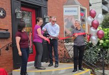 New owners Theresa Thibadeau and Mark Walsh cut the ribbon at the entrance to Grady's Feet Essentials at 231 King Street in downtown Peterborough as retiring owners Kelli and Tony Grady look on during a ceremony on September 1, 2026. (Photo courtesy of Grady's Feet Essentials)