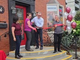 New owners Theresa Thibadeau and Mark Walsh cut the ribbon at the entrance to Grady's Feet Essentials at 231 King Street in downtown Peterborough as retiring owners Kelli and Tony Grady look on during a ceremony on September 1, 2026. (Photo courtesy of Grady's Feet Essentials)