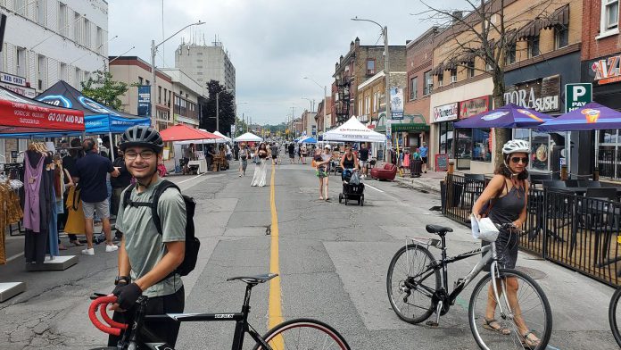 Downtown Peterborough's Second Saturday Sidewalk Sale on August 8, 2026 allowed people to experience Charlotte Street free of car traffic. Many Canadian cities are starting to reimagine their streets as places for pedestrians, not just cars. (Photo: Brett Throop / GreenUP)