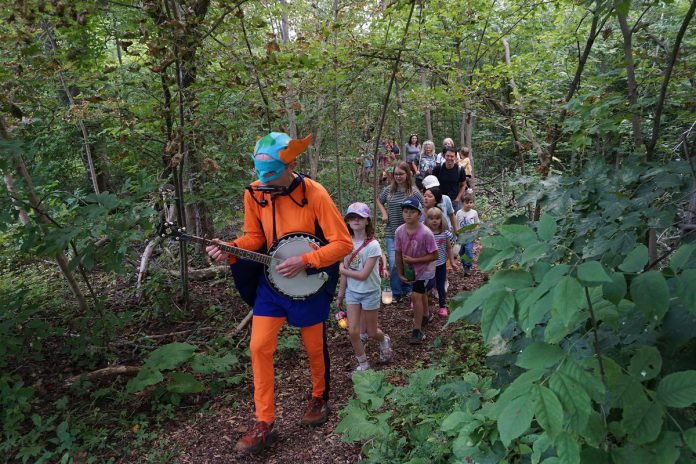 Glen Caradus' alter-ego, Cool Captain Climate, led families on a lantern-lit walk through the forest to close out GreenUP Ecology Park's Family Night on August 27, 2026. The lanterns were created by guests at a craft station earlier in the evening. (Photo: Alex Karn / GreenUP)