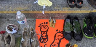 Children's shoes, toys, and offerings on the steps of Peterborough City Hall in June 2021 as part of a community memorial created in response to the discovery of the remains of 215 Indigenous children buried at the former Kamloops Indian Residential School in British Columbia. As well as remembering and honouring those lost to residential schools and the thousands of survivors, National Day for Truth and Reconciliation is a day for Canadians to educate themselves about the heritage, culture, stories, and experiences of First Nations, Inuit, and Métis peoples. (Photo: Bruce Head / kawarthaNOW)
