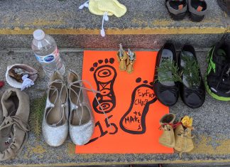 Children's shoes, toys, and offerings on the steps of Peterborough City Hall in June 2021 as part of a community memorial created in response to the discovery of the remains of 215 Indigenous children buried at the former Kamloops Indian Residential School in British Columbia. As well as remembering and honouring those lost to residential schools and the thousands of survivors, National Day for Truth and Reconciliation is a day for Canadians to educate themselves about the heritage, culture, stories, and experiences of First Nations, Inuit, and Métis peoples. (Photo: Bruce Head / kawarthaNOW)