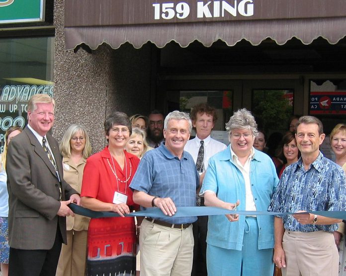 In 2003, Workforce Development Board (WDB) officially opened its office at 159 King Street in downtown Peterborough, where the not-for-profit organization remained until early 2026 when it moved to Launch Kawartha in Lindsay. Pictured is former WDB CEO Gord Evans (front left) holding the ribbon as former Peterborough mayor Sylvia Sutherland cuts it, with the late Peterborough MP Peter Adams standing to her right. (Photo courtesy of WDB)