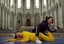 Once again clad in their yellow and purple velour tracksuits, Linda "The Liquidator" Kash and Megan "The Mauler" Murphy are gearing up to host the fifth annual Cancer Takedown on November 5, 2026 at Market Hall Performing Arts Centre in downtown Peterborough. The fundraiser for cancer care at Peterborough Regional Health Centre (PRHC) and "spirit-raiser" for anyone touched by cancer will include music from Melissa Payne, Kate Suhr, Kate Brioux, Beau Dixon, The Weber Brothers, Nicholas Campbell, Brandon Munroe, Ian McKeown, Anthony Bastianon, and Good Medicine. (Photo courtesy of Amy Kemp)