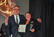 Tourism Industry Association of Ontario president and CEO Andrew Siegwart presents the organization's Attraction of the Year award to The Canadian Canoe Museum's marketing and communications manager Jaimie Eastabrook during the Ontario Tourism Awards of Excellence Gala on October 22, 2026. (Photo courtesy of The Canadian Canoe Museum)