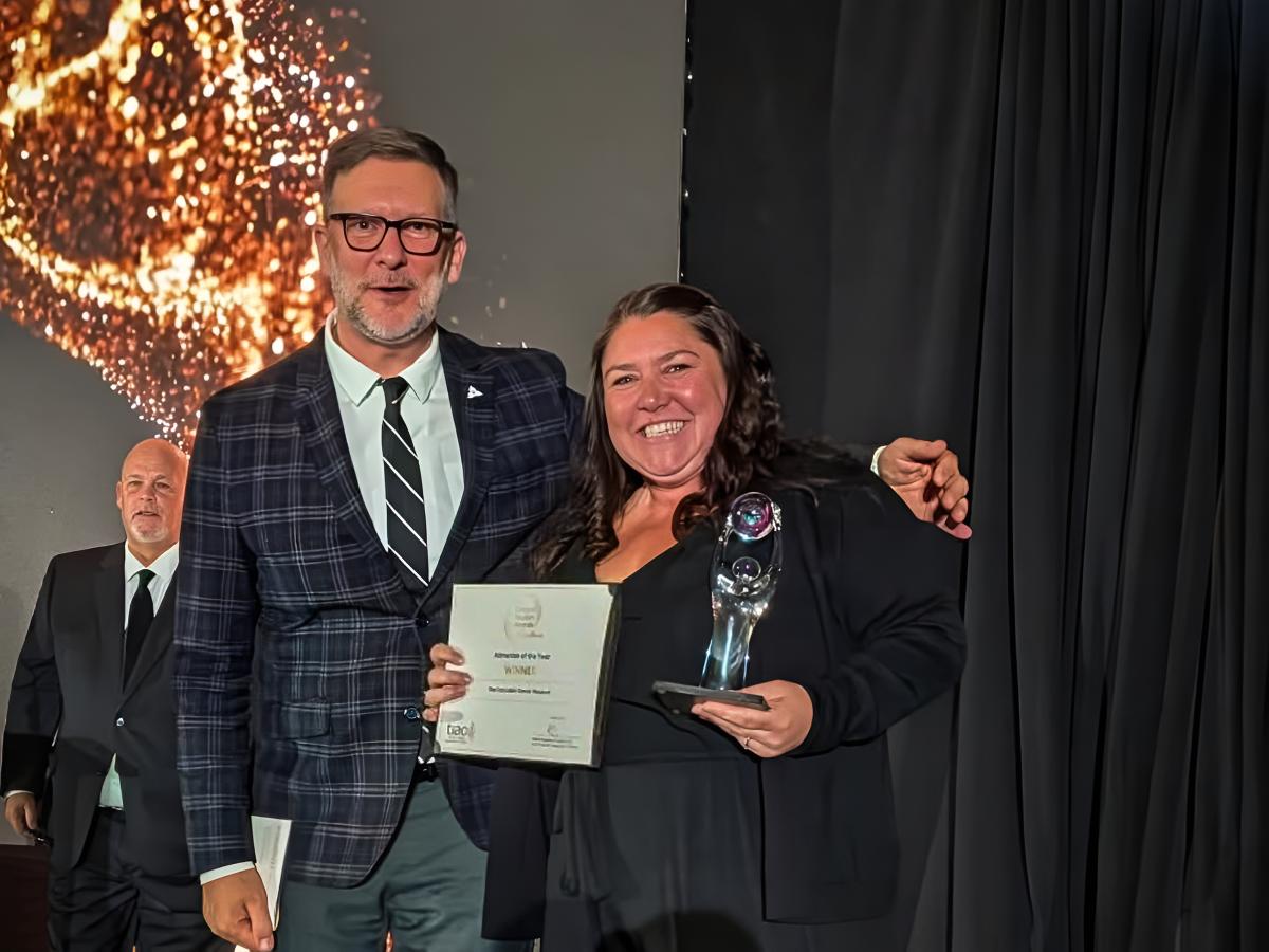 Tourism Industry Association of Ontario president and CEO Andrew Siegwart presents the organization's Attraction of the Year award to The Canadian Canoe Museum's marketing and communications manager Jaimie Eastabrook during the Ontario Tourism Awards of Excellence Gala on October 22, 2026. (Photo courtesy of The Canadian Canoe Museum)