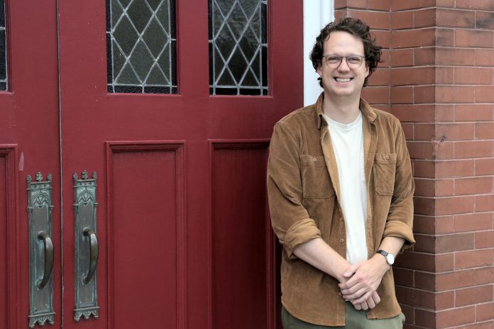 Colin McMahon has been appointed the new executive director of the Kawartha Youth Orchestra (KYO). Pictured at the KYO's home at the New Canadians Centre, McMahon has served as program manager and artistic director of Upbeat!, KYO's subsidized after-school music education program, for the past three years. (Photo: Samantha Haggstrom / KYO) Colin McMahon has been appointed the new executive director of the Kawartha Youth Orchestra (KYO). Pictured at the KYO's home at the New Canadians Centre, McMahon has served as program manager and artistic director of Upbeat!, KYO's subsidized after-school music education program, for the past three years. (Photo: Samantha Haggstrom / KYO)
