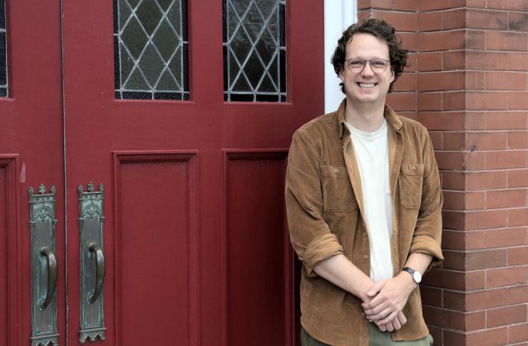 Colin McMahon has been appointed the new executive director of the Kawartha Youth Orchestra (KYO). Pictured at the KYO's home at the New Canadians Centre, McMahon has served as program manager and artistic director of Upbeat!, KYO's subsidized after-school music education program, for the past three years. (Photo: Samantha Haggstrom / KYO)