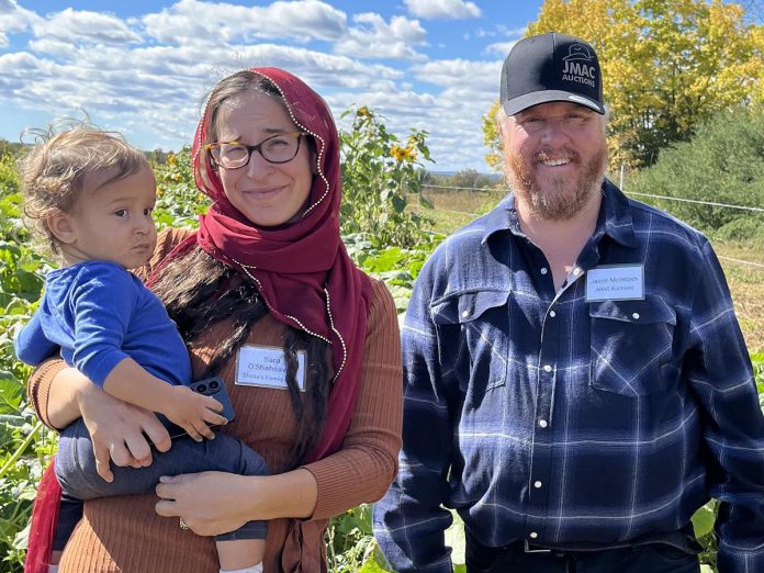 Peterborough Community Farm pilot farmer Sara O. Shahsavari of Sheila's Family Farm (with baby Zayid) and Jason McIntosh of JMAC Auctions, who owns the farm property at 1576 Matchett Line in Otonabee-South Monaghan, during during Farms at Work's official launch event for the community farm on October 3, 2026. (Photo courtesy of Farms at Work)