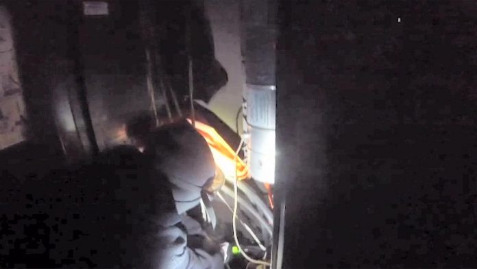 A video provided by a group claiming to be Palestine Action Canada showing a masked individual interfering with unidentified equipment in the early morning hours of October 12, 2026. Peterborough police said an outdoor communications box was damaged at GeoSpectrum Technologies Inc. on Whittington Drive in Peterborough. (kawarthaNOW screenshot)