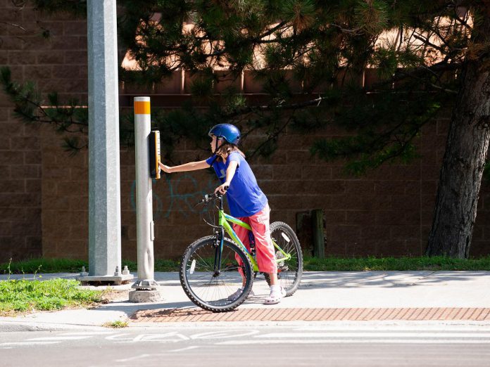 Safety for kids walking and biking to school depends on the built environment around them. Sidewalks, signalized crossings, and pavement markings all contribute to increased safety and ease getting around. (Photo: Pete Rellinger)