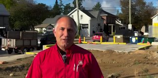 Kawartha Home Hardware general manager Garnet Hinds at the site of the former historic Kawartha Home Hardware building at 24 Queen Street in downtown Lakefield, which was demolished after being severely damaged in a fire on October 9, 2025. In a video posted on social media on October 8, 2026, Hinds says construction on a new building is ready to proceed. (kawarthaNOW screenshot)