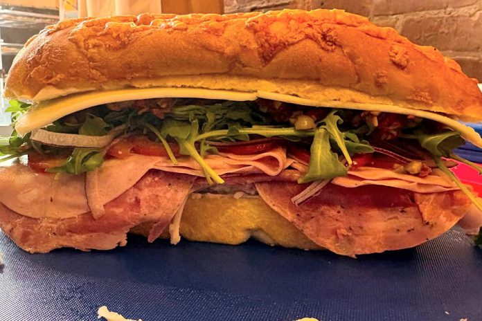 The veteran-owned Mindful Crowe Lunchbox in Marmora serves a famous muffuletta sandwich, made with three Italian meats, two cheeses, an olive tapenade, roasted red pepper, Italian dressing, and other vegetables. In store, you'll also find a selection of housemade preserves, jams, sauces, and other goods. (Photo courtesy of Mindful Crowe Lunchbox)