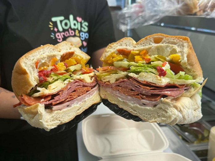 Tobi's Grab and Go Sandwiches is a new sandwich shop located in Bancroft serving up specialty and classic sandwiches. One of the most popular is the Jacob's Big Boy Sandwich, made with ham, salami, pepperoni, spicy cheese, hot peppers, lettuce, tomato, and pickles. Using nearly half a loaf of bread for a truly hearty meal, these are not for the faint of heart and can be served cold or panini pressed. (Photo courtesy of Tobi's Grab and Go Sandwiches)