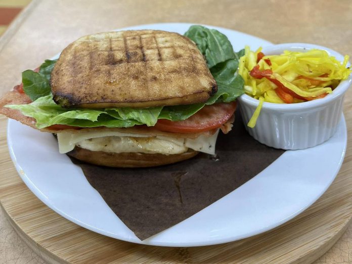 One of the most popular sandwiches at Wattle & Daub in Bancroft is the Chicken BLT, made with a full roasted chicken breast and layered with bacon, Swiss cheese, tomato, lettuce, and a signature spicy mayo on an artisan bun. Boasting a new courtyard, Wattle & Daub is a social enterprise supporting Bancroft Community Transit, which provides door-to-door transportation across North Hastings. (Photo courtesy of Wattle & Daub)