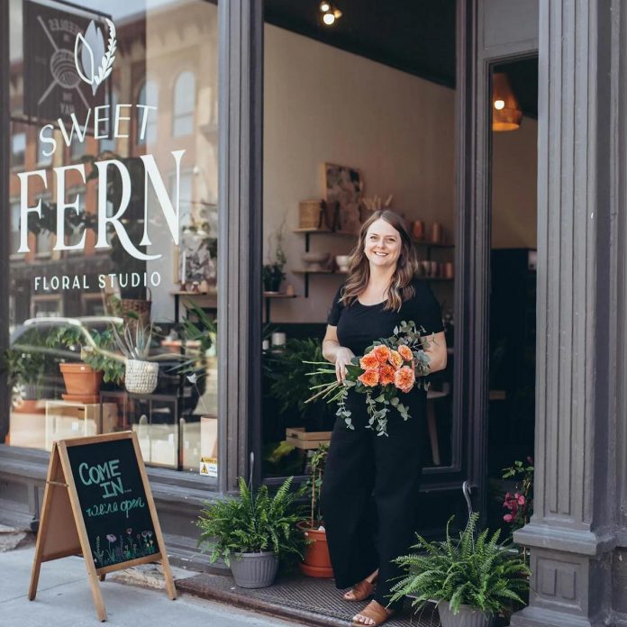 Owner Angela McDonald stands outside Sweet Fern Floral Studio at 387 Water Street in downtown Peterborough, which will be moving to 208 Charlotte Street on November 3, 2026. What began as a small business with McDonald curating floral arrangements in her basement has grown into a seven-employee shop, with the move to Charlotte Street providing Sweet Fern with three times as much space, allowing the flower shop to expand their selection of home décor and goods sold alongside pre-arranged and custom bouquets. (Photo courtesy of Sweet Fern Floral Studio)