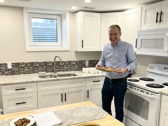 One City Peterborough's director of property development Michael VanDerHerberg in the kitchen of a self-contained basement apartment, which is part of a partnership with Peterborough Action for Tiny Homes (PATH) to construct additional rental units that provide supportive housing options for tenants of residential properties owned by One City Peterborough. (Photo courtesy of One City Peterborough)