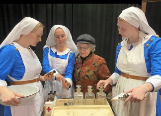 Pictured with director Bea Quarrie, Rebecca Birrell (left), Laura Lawson, and Emily Kelly perform as Canadian military nurses Bab, Maggie, and Christy in the Peterborough Theatre Guild's production of Vern Thiessen's drama "Bluebirds," which runs for 10 performances from October 30 to November 14, 2026. The play follows the three women as they care for wounded Canadian soldiers in 1918 France, gradually developing a friendship as they strive to stay hopeful while the dangers of the front draw closer to their hospital. (Photo: Paul Rellinger / kawarthaNOW)