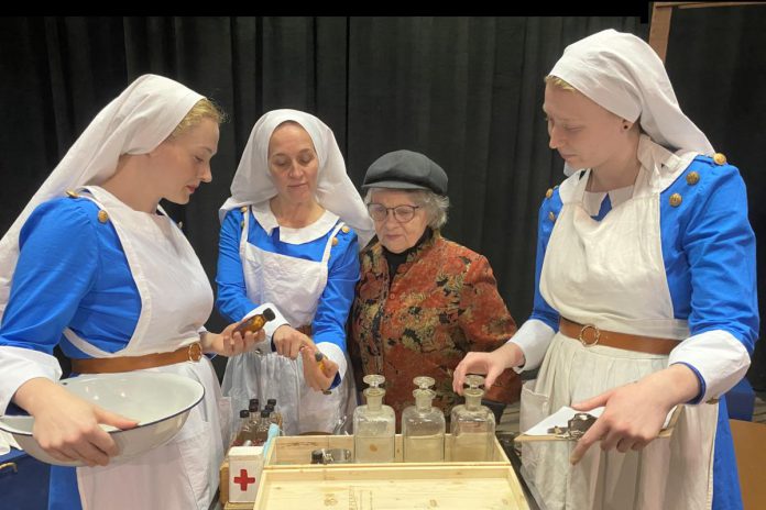 Pictured with director Bea Quarrie, Rebecca Birrell (left), Laura Lawson, and Emily Kelly perform as Canadian military nurses Bab, Maggie, and Christy in the Peterborough Theatre Guild's production of Vern Thiessen's drama "Bluebirds," which runs for 10 performances from October 30 to November 14, 2026. The play follows the three women as they care for wounded Canadian soldiers in 1918 France, gradually developing a friendship as they strive to stay hopeful while the dangers of the front draw closer to their hospital. (Photo: Paul Rellinger / kawarthaNOW)