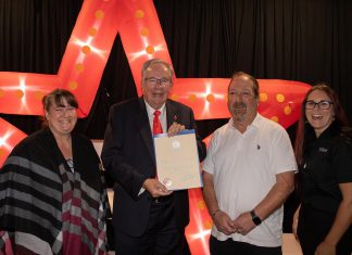 The Venue in downtown Peterborough celebrates five years of family ownership Peterborough mayor Jeff Leal presents a certificate of recognition of five years of family ownership from the City of Peterborough to The Venue owners April Sendel (left) and Kevin Sendel (second from right) and general manager Tiffany Daskewich (right) during a celebration at the downtown Peterborough event space on October 13, 2026. (Photo: Joshua Gillis)